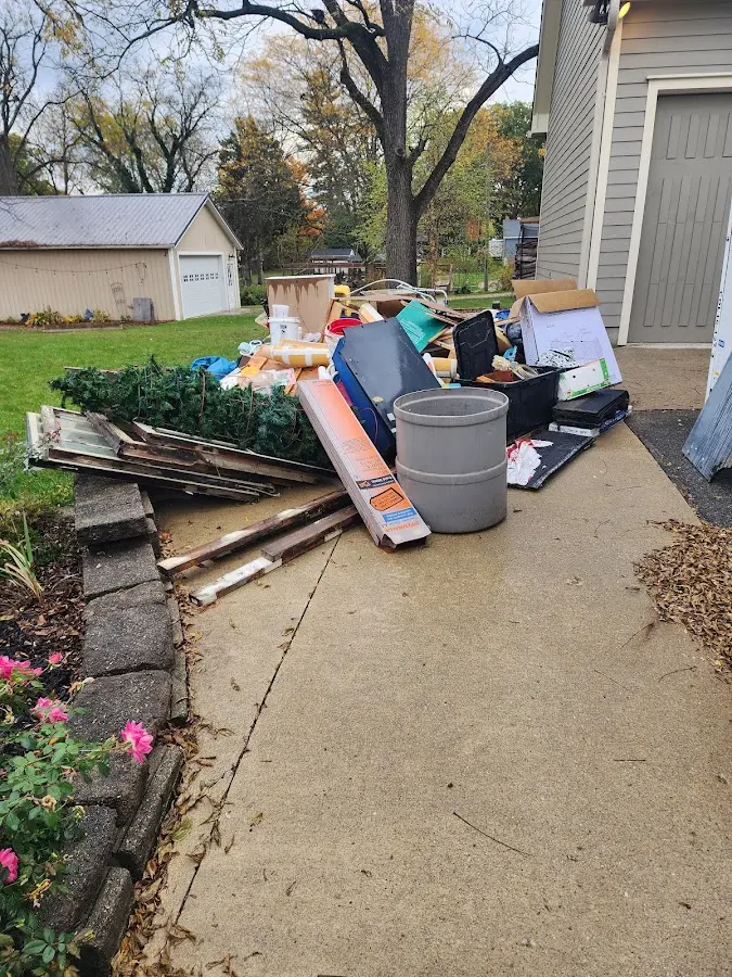 Dumpster being loaded with debris for Estate Cleanout Dumpster Rental in Round Rock